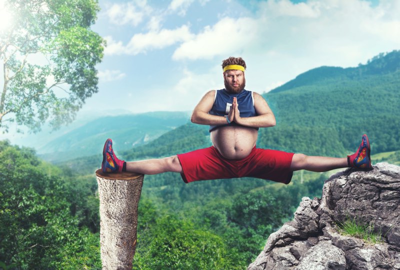 Man doing splits between rocks